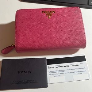 Prada pink used wallet. Comes with the tag, but I don’t have the dust bag